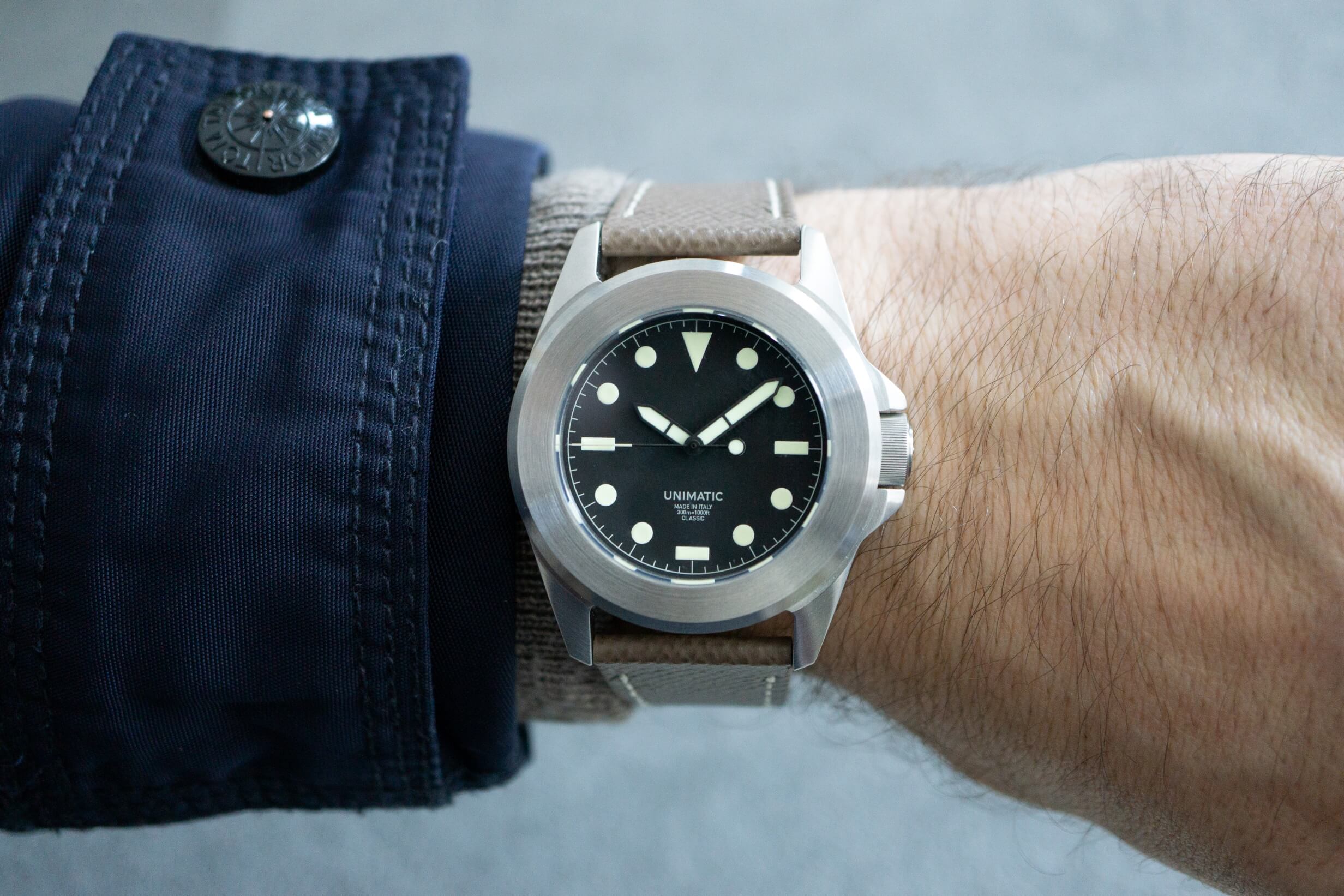 A taupe leather watch strap paired with the Unimatic UC4